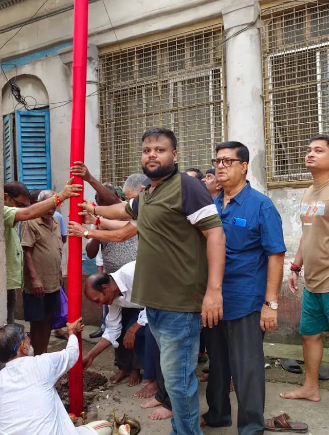 Khuti puja — members raise the sacred bamboo pole that begins the season