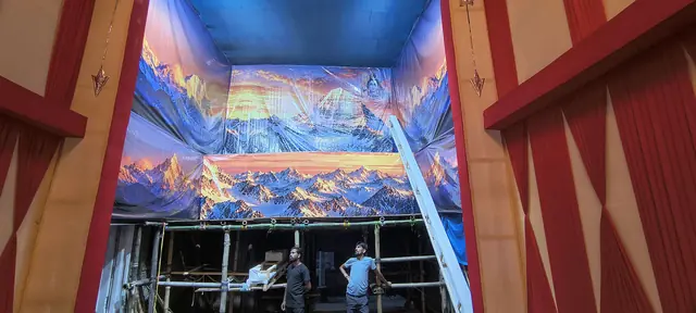 The Himalayan backdrop goes up inside the pandal