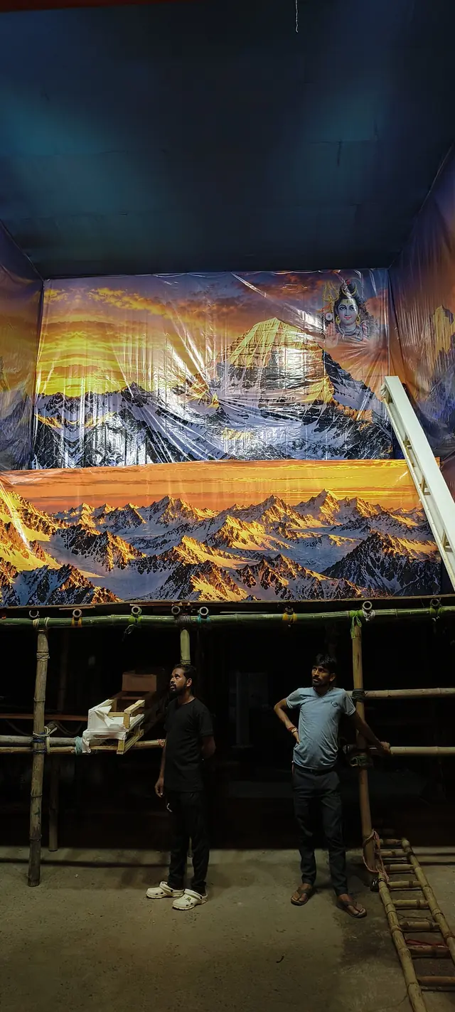 Work continues on the pandal and its mountain backdrop