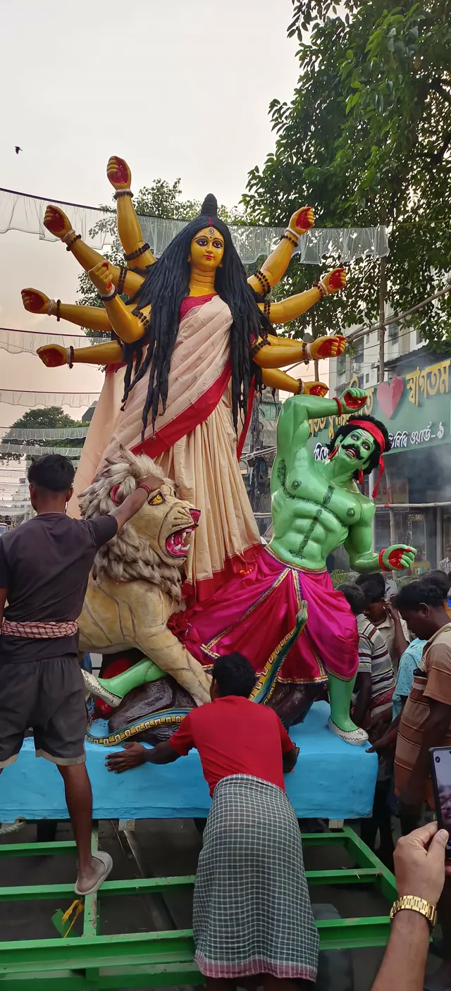 Ma Durga, with her lion and Mahishasura, arrives on a cart