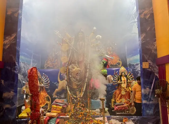 Aarti smoke drifts before the goddess